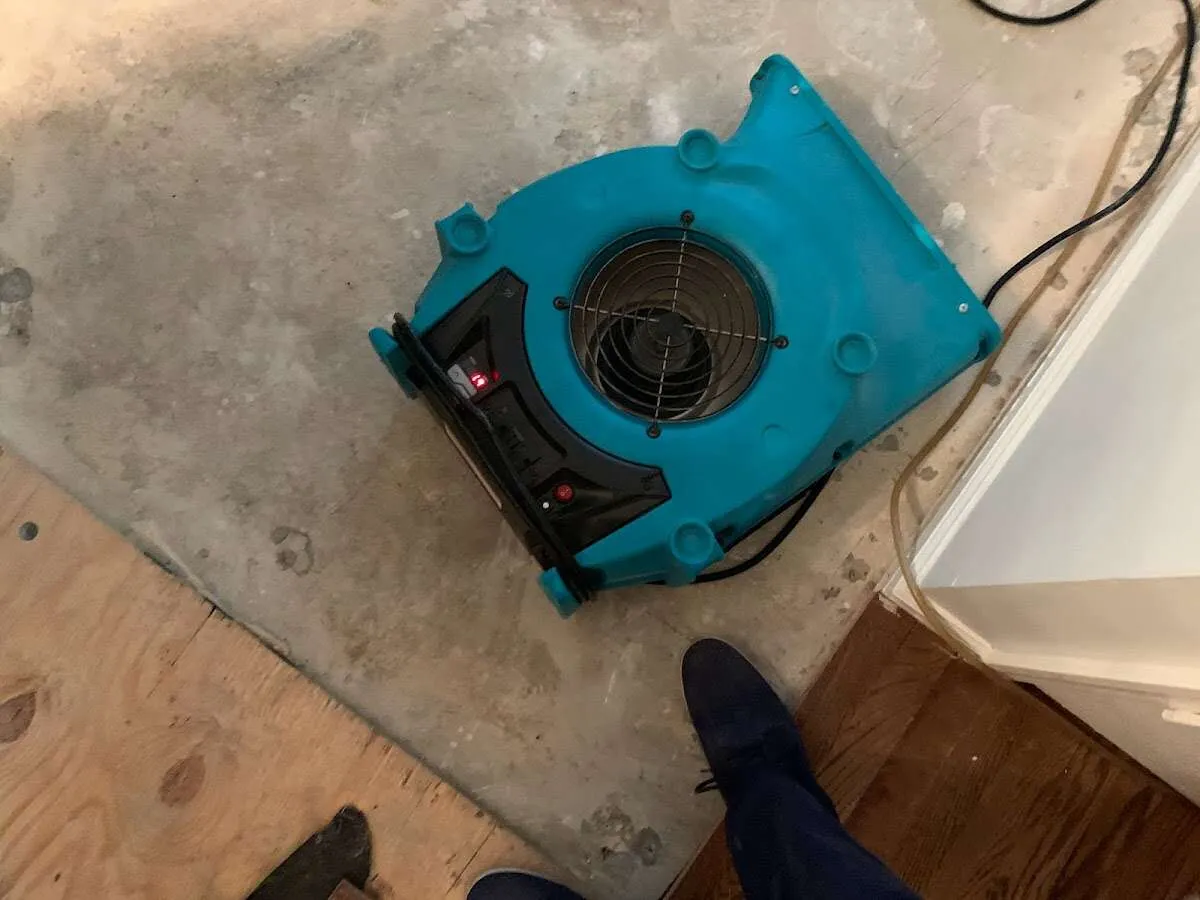 Air mover drying subfloor during Commercial Water Damage Restoration in Avon Lake